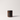 An amber glass jar candle with a black metal lid and a black label reading 'FILTHY FLORAL' on a clean white background.